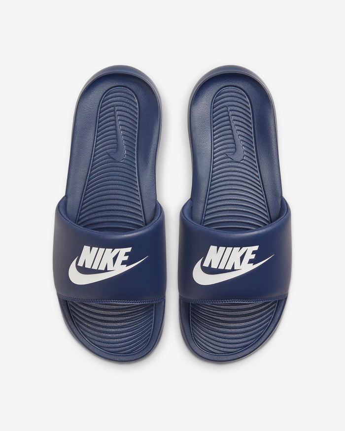 Navy slide sandal with a brand logo on a light gray background