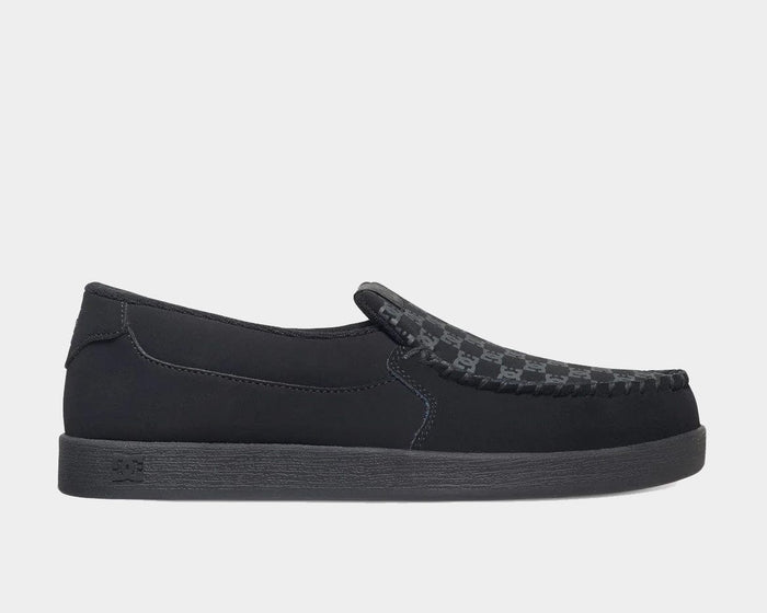 DC Footwear Villain 2 slip-on shoes in black with textured patterned vamp and stitched details, side view.