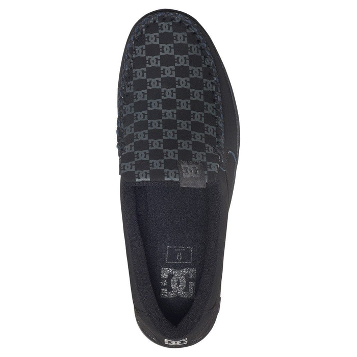 DC Footwear Villain 2 slip-on shoes with black and gray logo pattern on canvas upper, top view showing moccasin-style stitching.