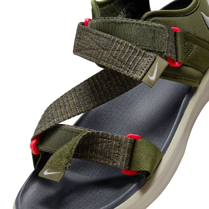 Nike Vista sandals in olive green with textured adjustable straps, red accents, and gray cushioned footbed, close-up angle.