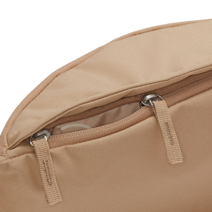 Nike Waist Pack in beige with durable fabric and zippered compartment, close-up view of zippers and stitching details.
