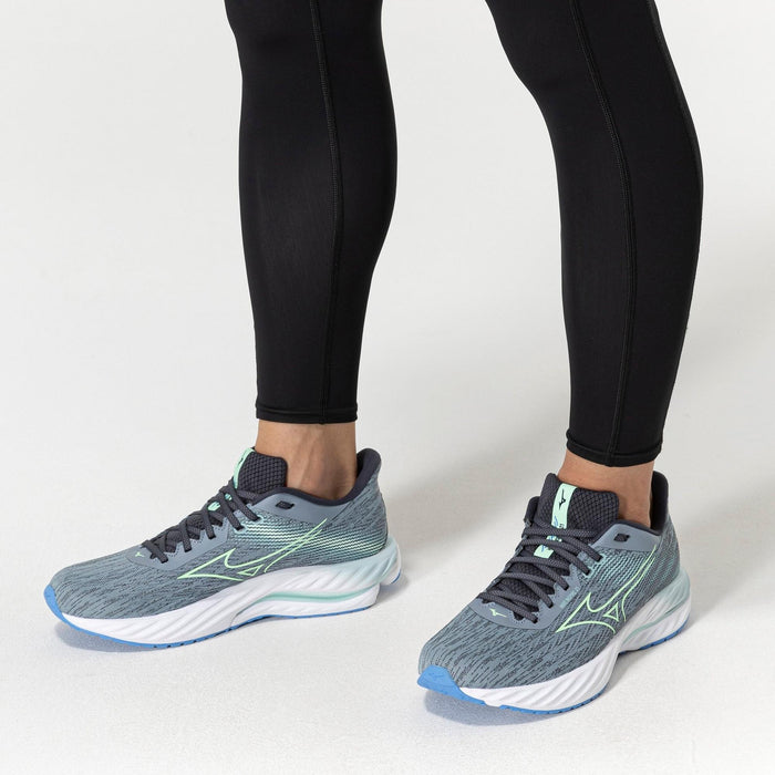 Mizuno Wave Inspire 21 running shoes in blue and gray with mint accents and wave cushioning, worn during activity.