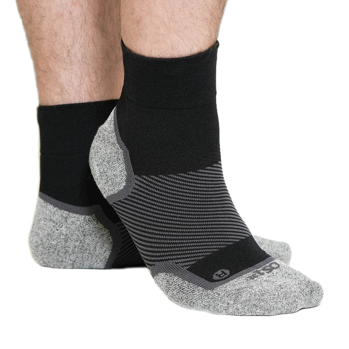 OS1st Wellness Performance Quarter Socks in black and gray with targeted compression zones, worn by person.