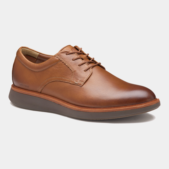 Johnston & Murphy XC+ Parker shoes in tan leather with lace-up design, cushioned sole, and rounded toe, side view.