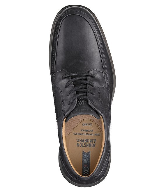 Johnston & Murphy XC4 Stanton 2.0 Waterproof Moc Toe shoe in black leather with lace-up design, top view showing cushioned insole detail.