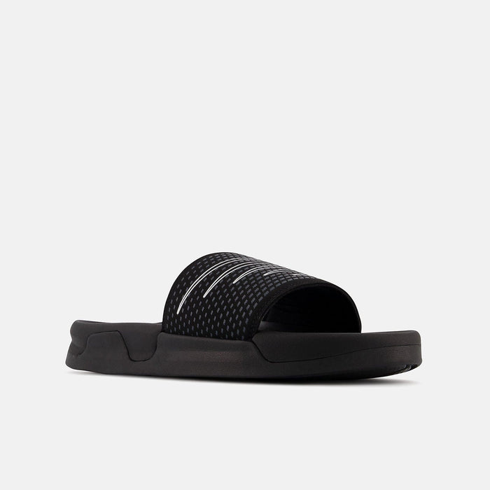 New Balance Zare Comfort slides in black with textured strap and cushioned sole, angled side view.