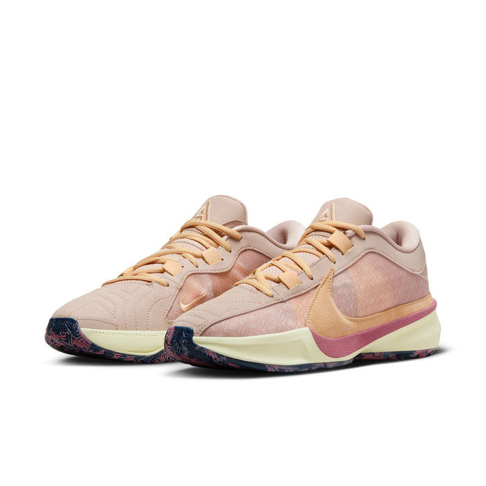 Nike Zoom Freak 5 basketball shoes in beige and peach with patterned mesh upper, cushioned midsole, and multicolor outsole, front side view.